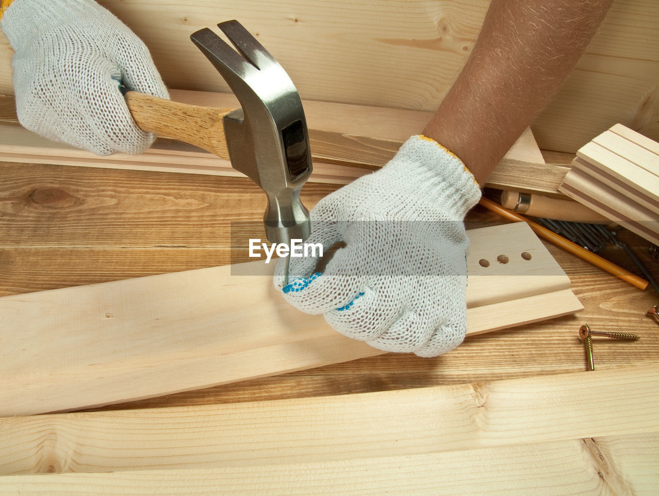 Close-up of carpenter hammering wood