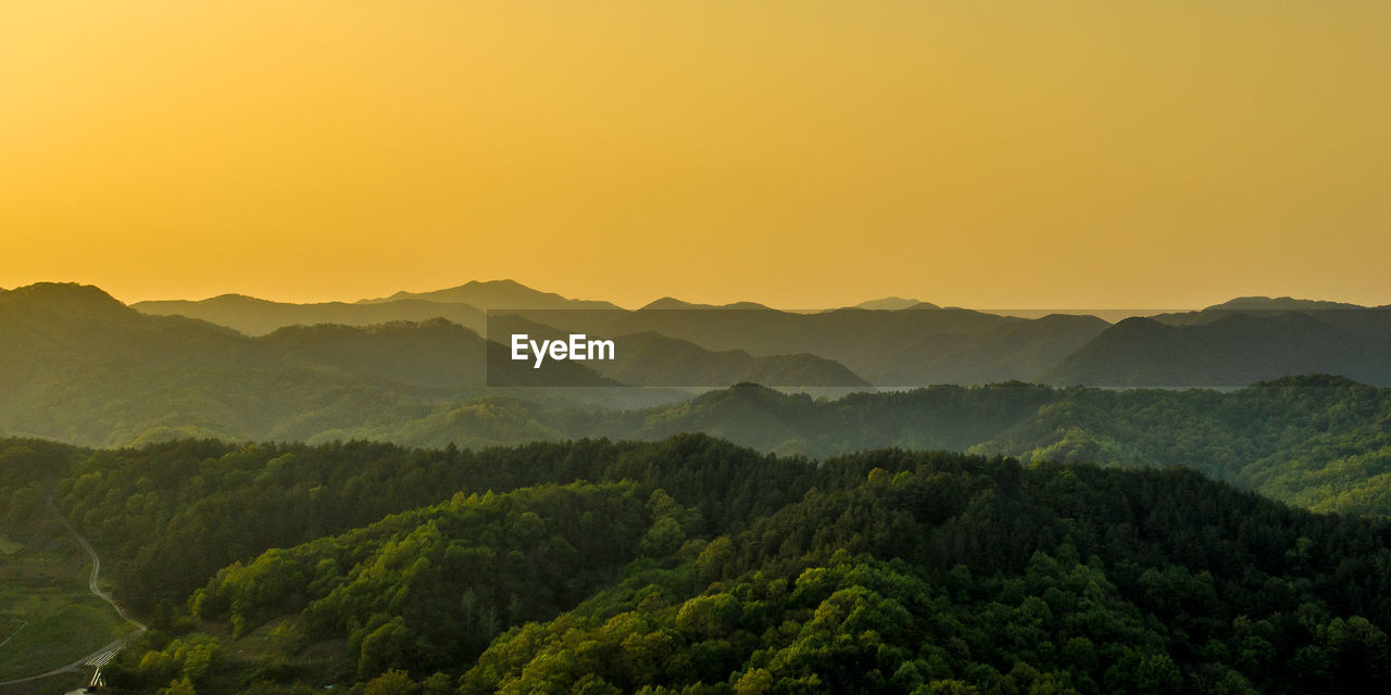 Scenic view of mountains against sky during sunset