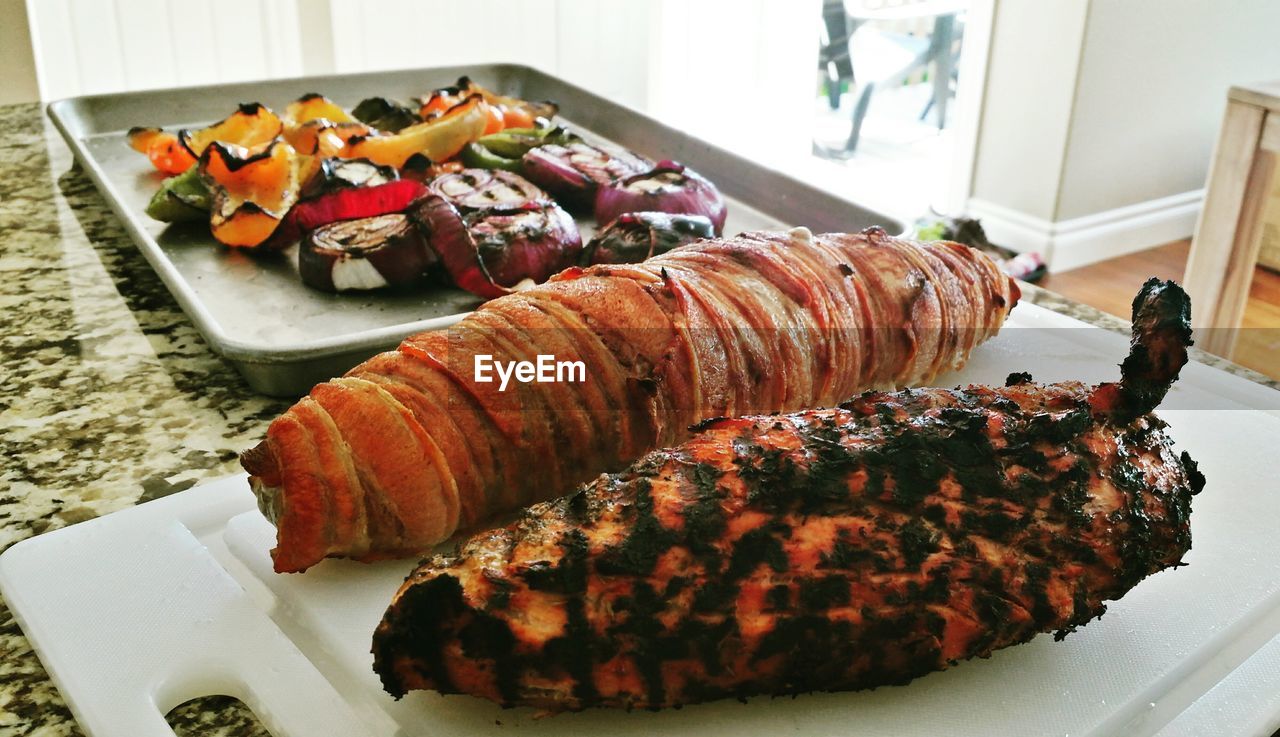 CLOSE-UP OF MEAT ON TABLE