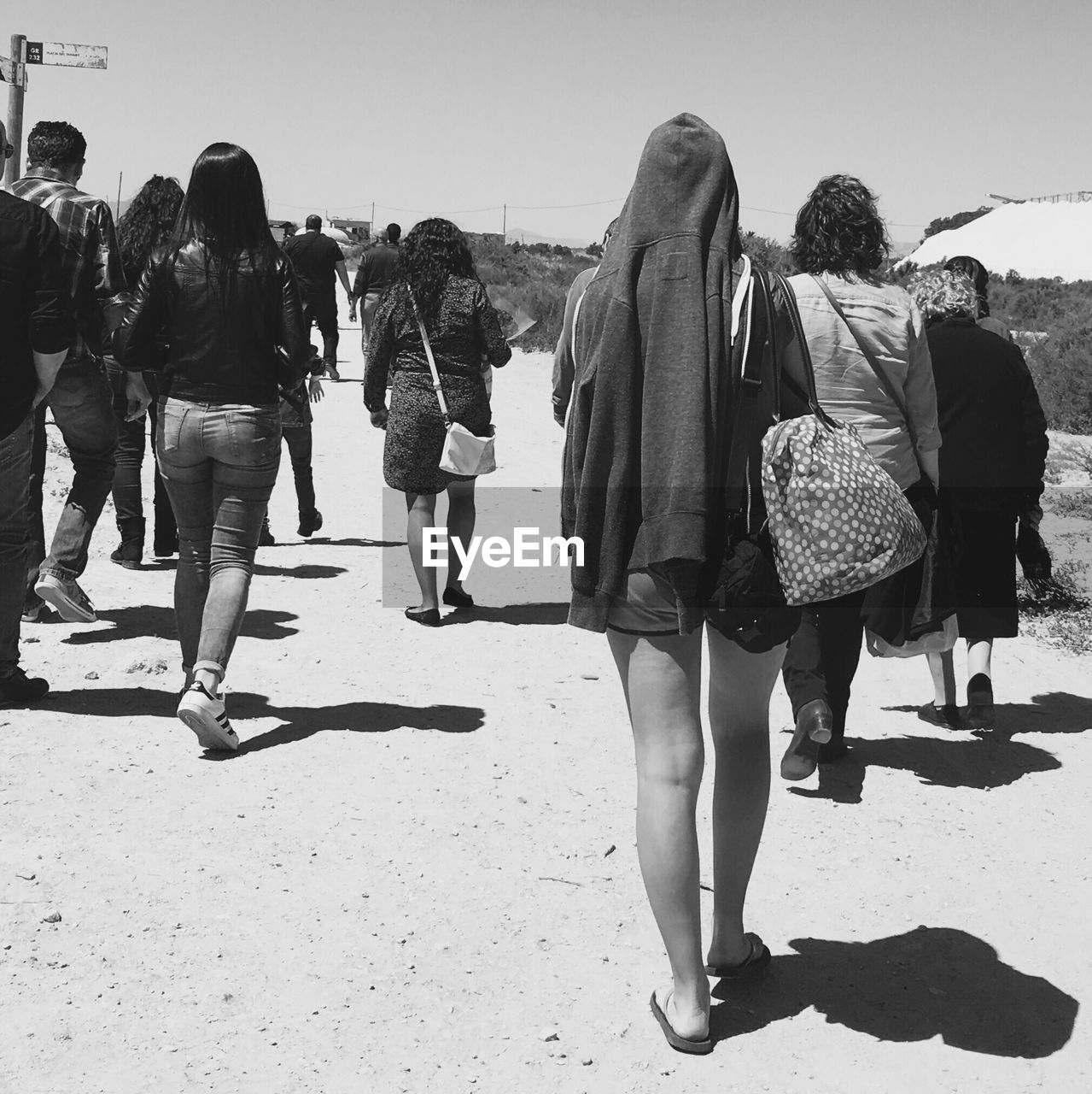 Rear view of people walking on beach