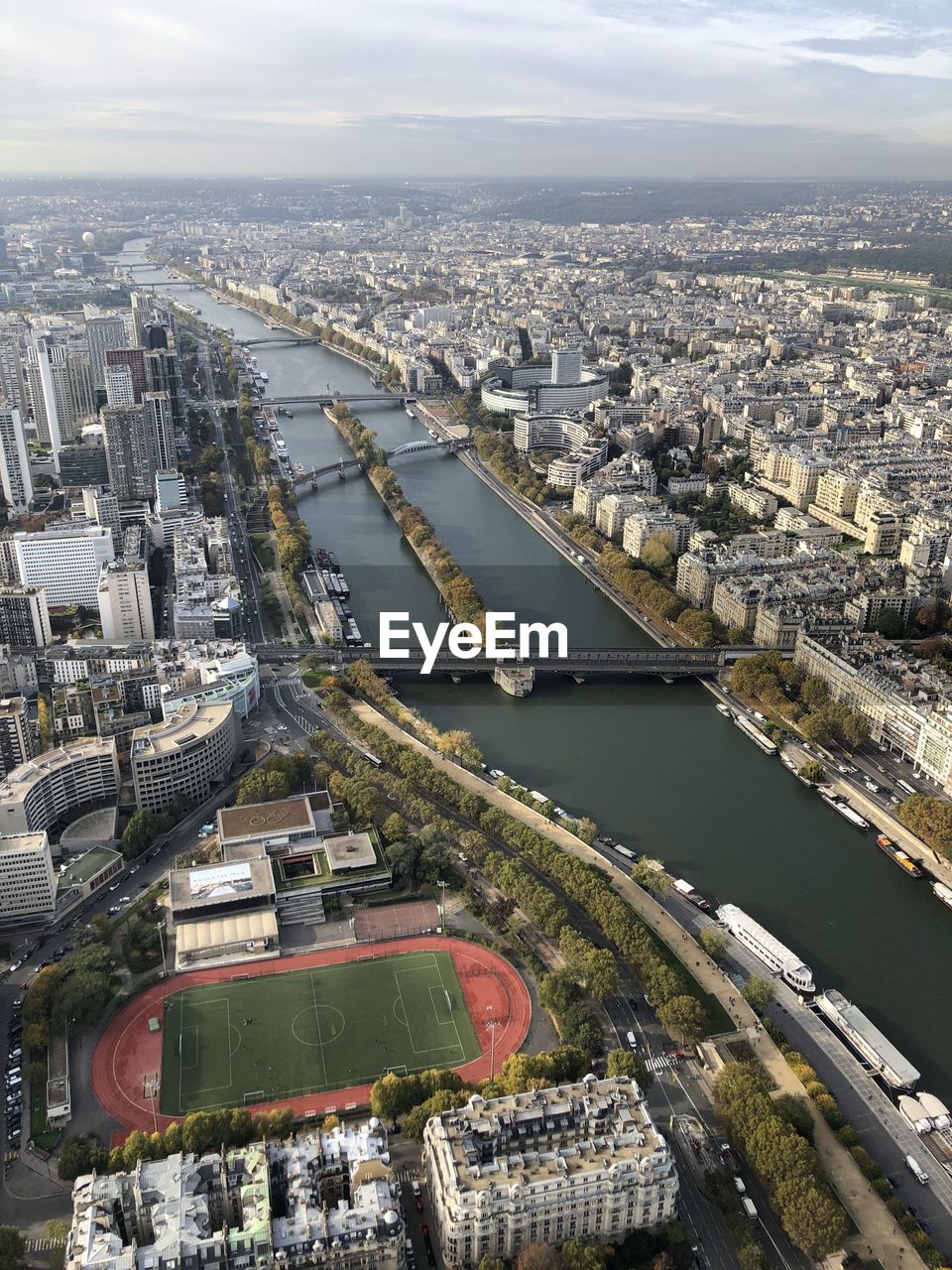 HIGH ANGLE VIEW OF BRIDGE OVER RIVER AND BUILDINGS IN CITY