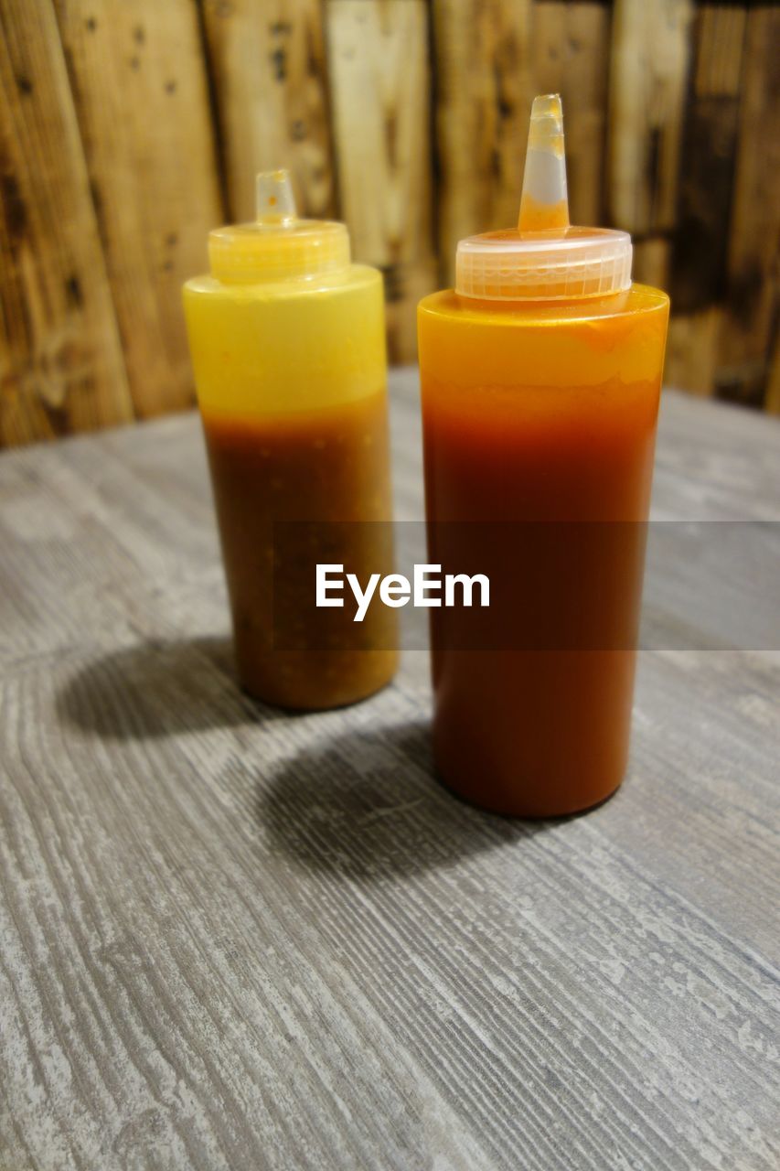 Close-up of sauce bottles on table at restaurant