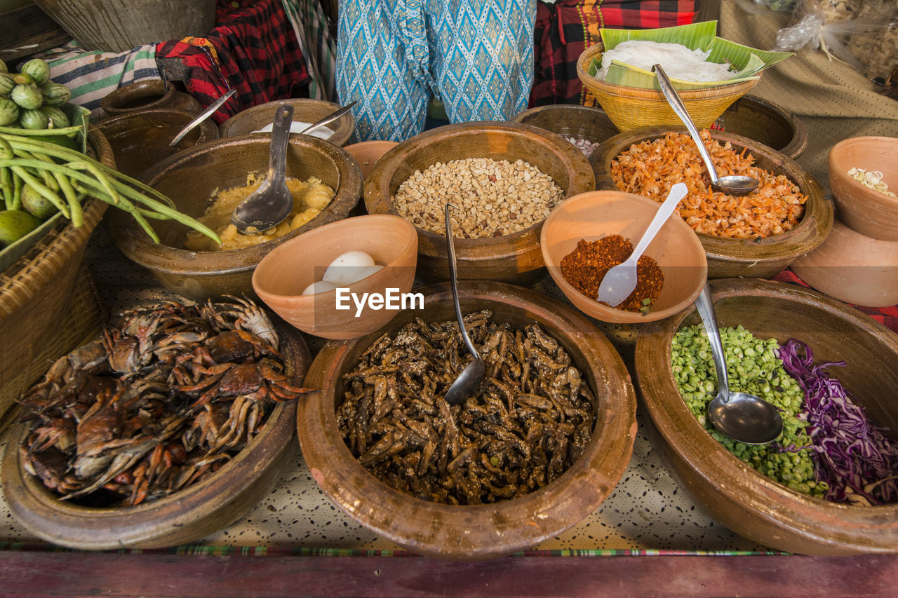 HIGH ANGLE VIEW OF VARIOUS FOOD ON TABLE AT MARKET STALL