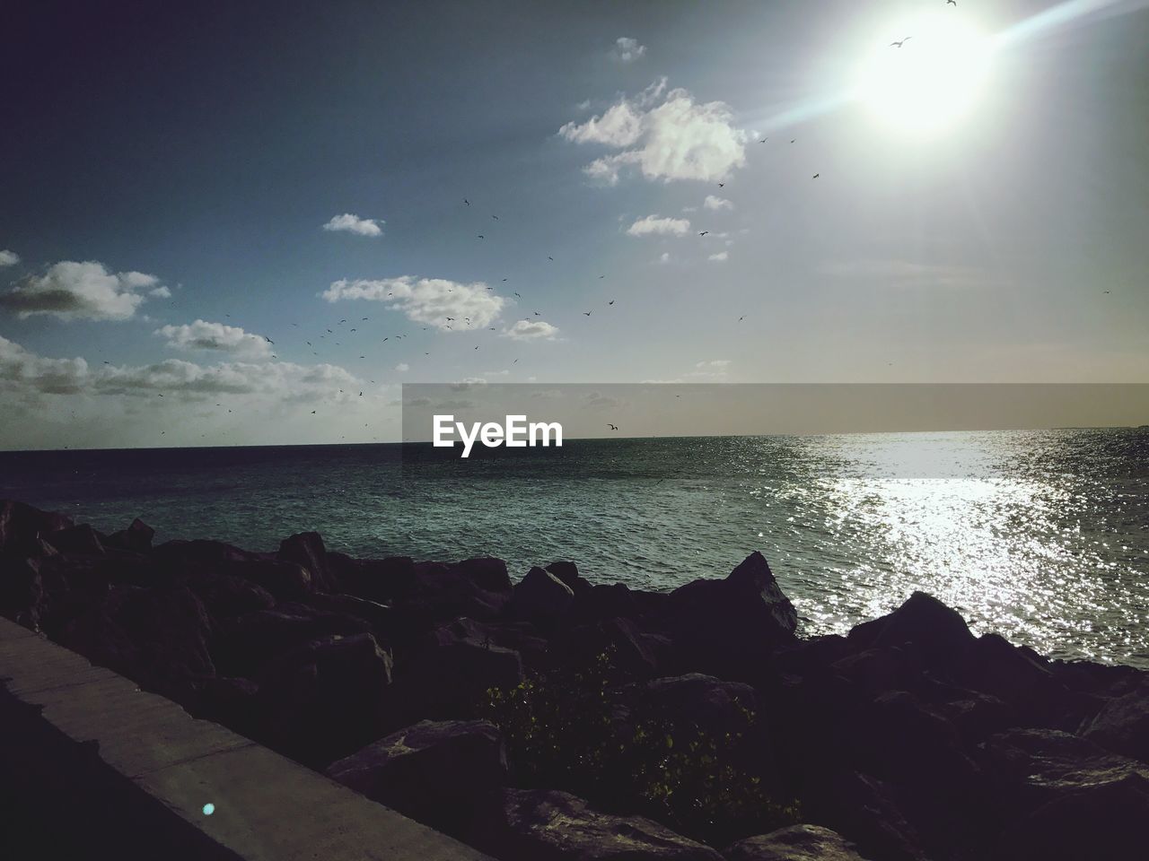 SCENIC VIEW OF BEACH AGAINST SKY DURING SUNSET