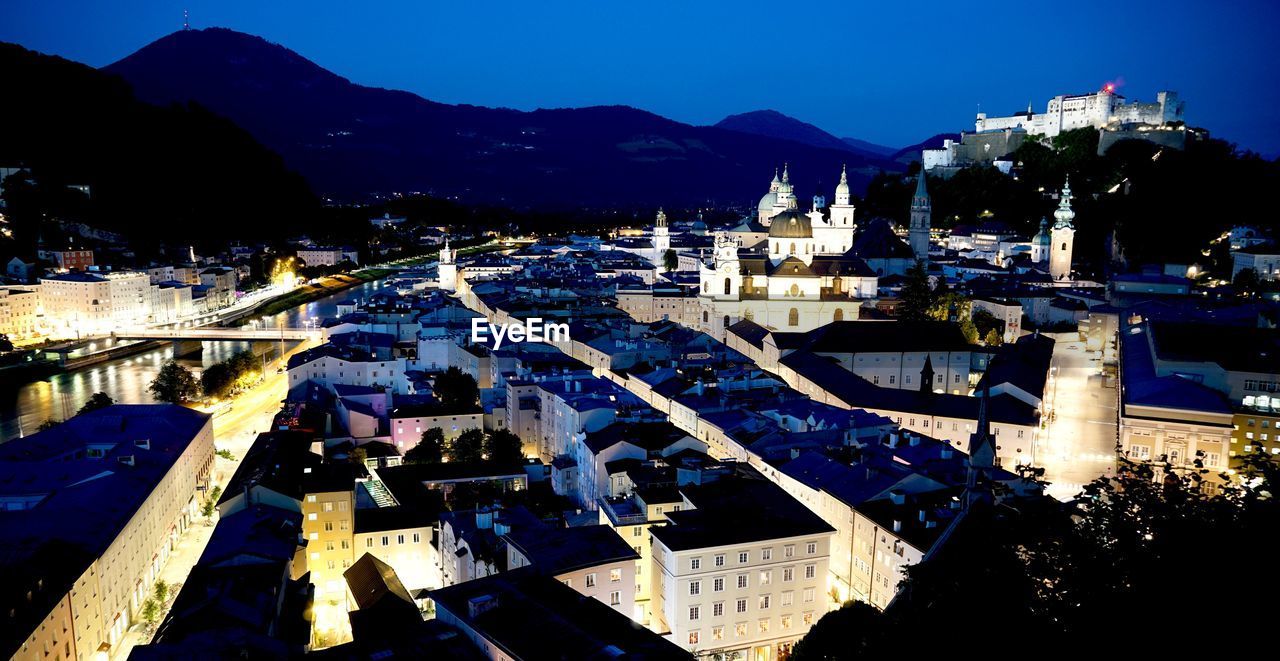 High angle view of buildings in city at night