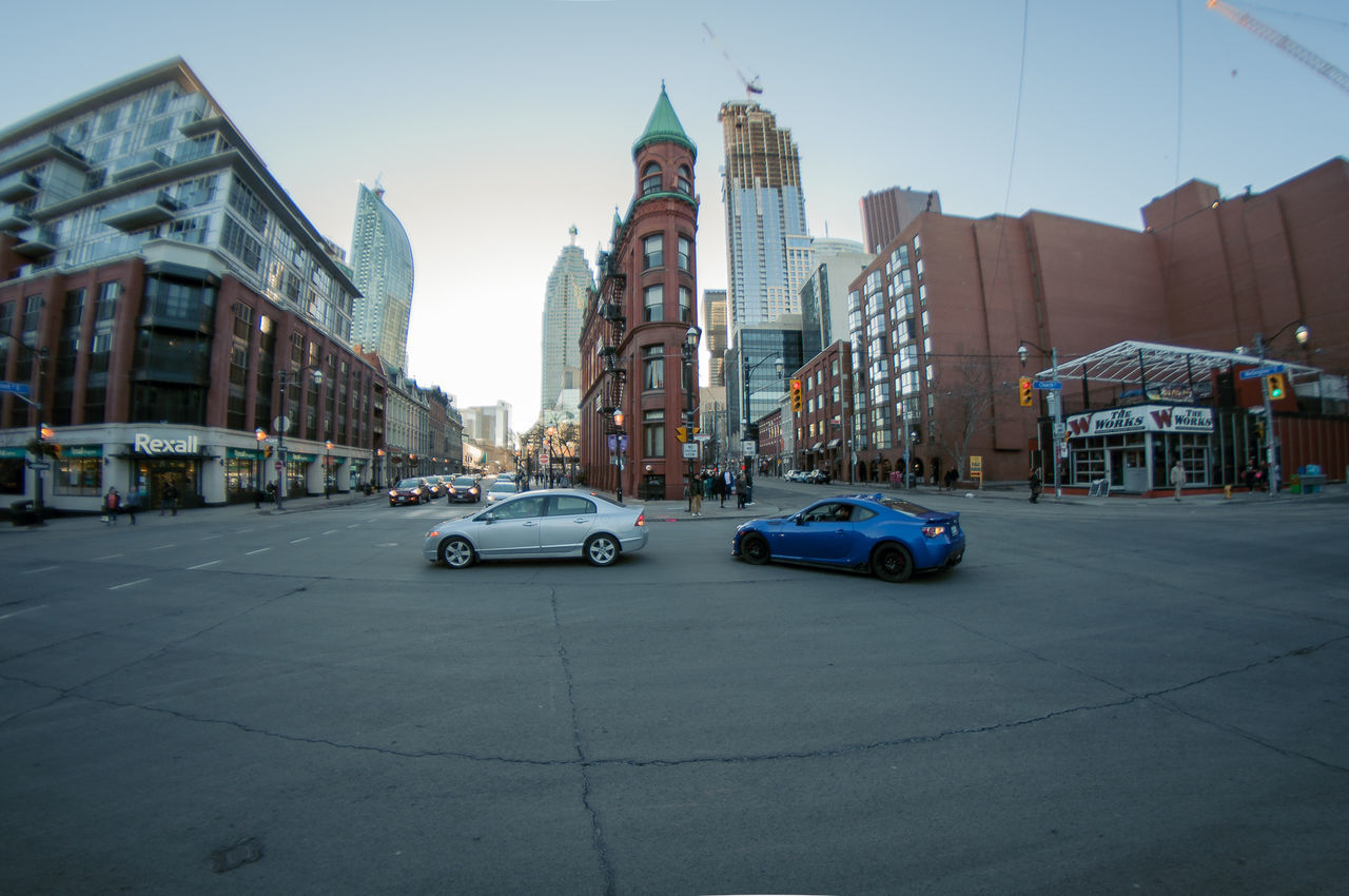 CARS ON CITY AGAINST SKY