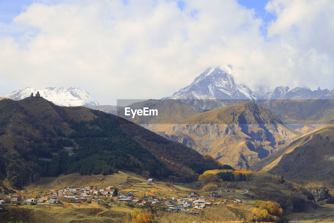 Scenic view of mountains against cloudy sky