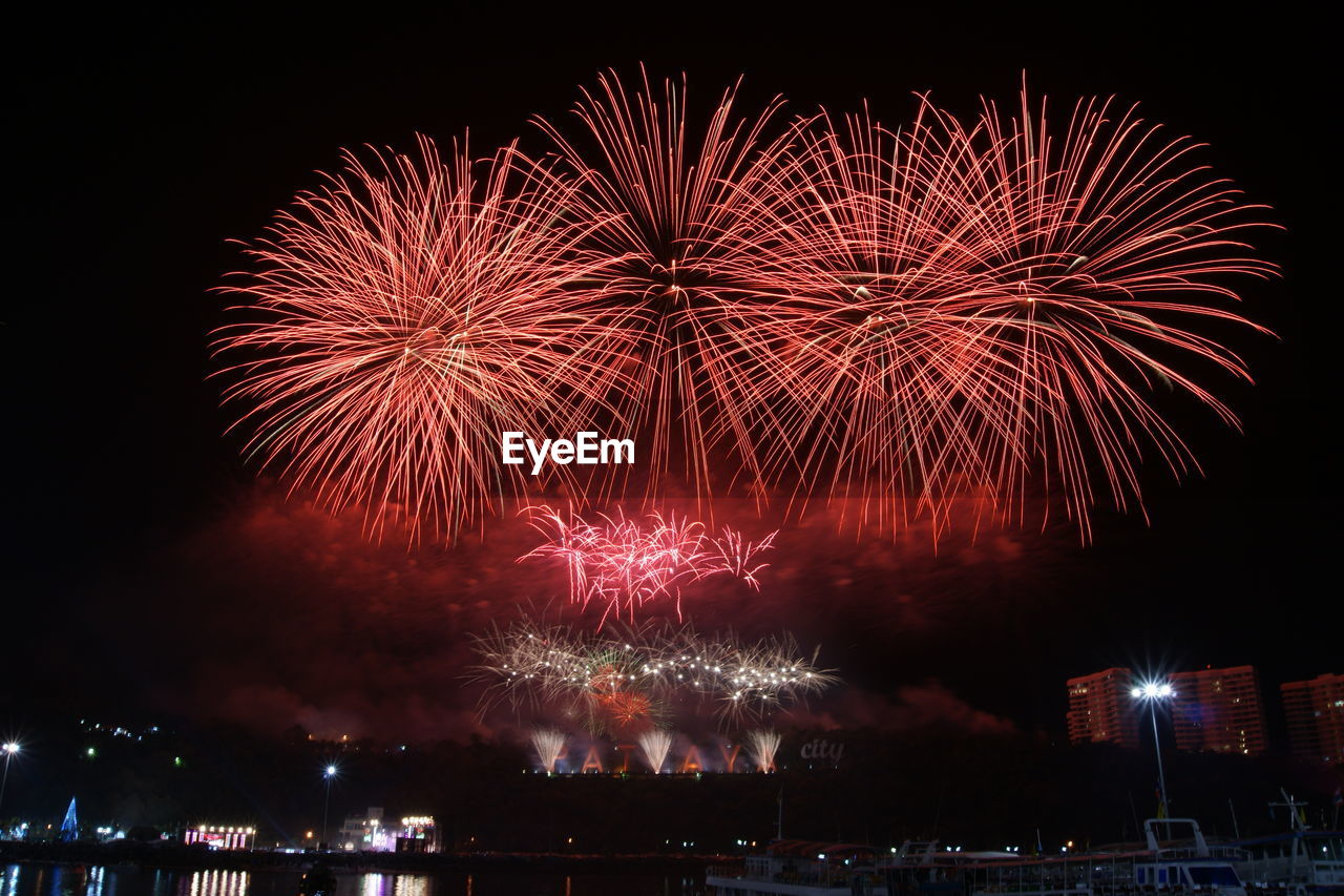 Low angle view of firework display at night