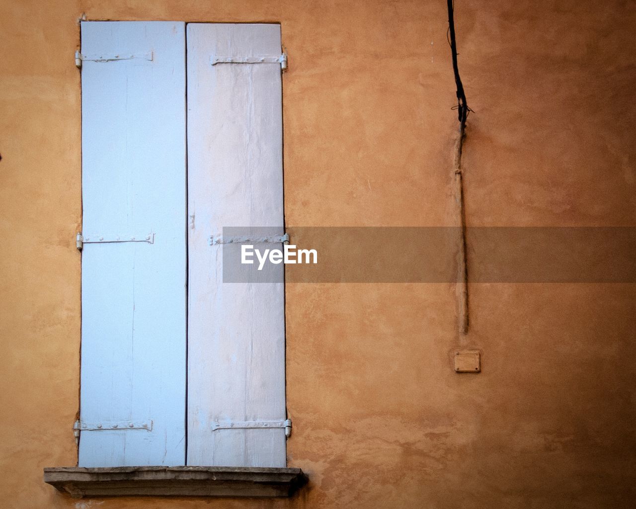 Close-up of closed window on wall