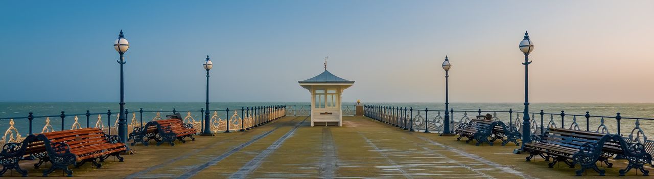 Street lights on pier at sea