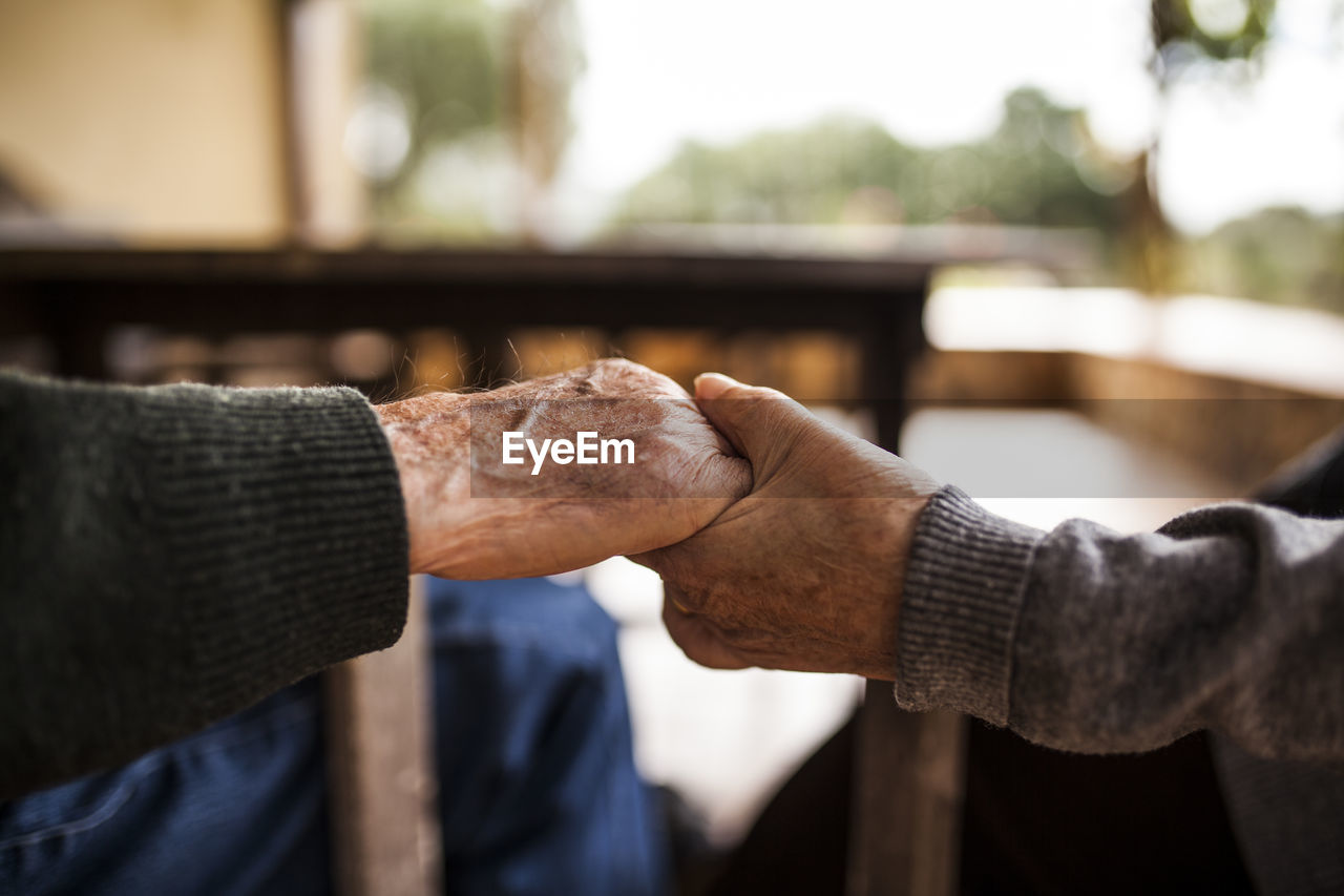 Elderly couple shaking hands