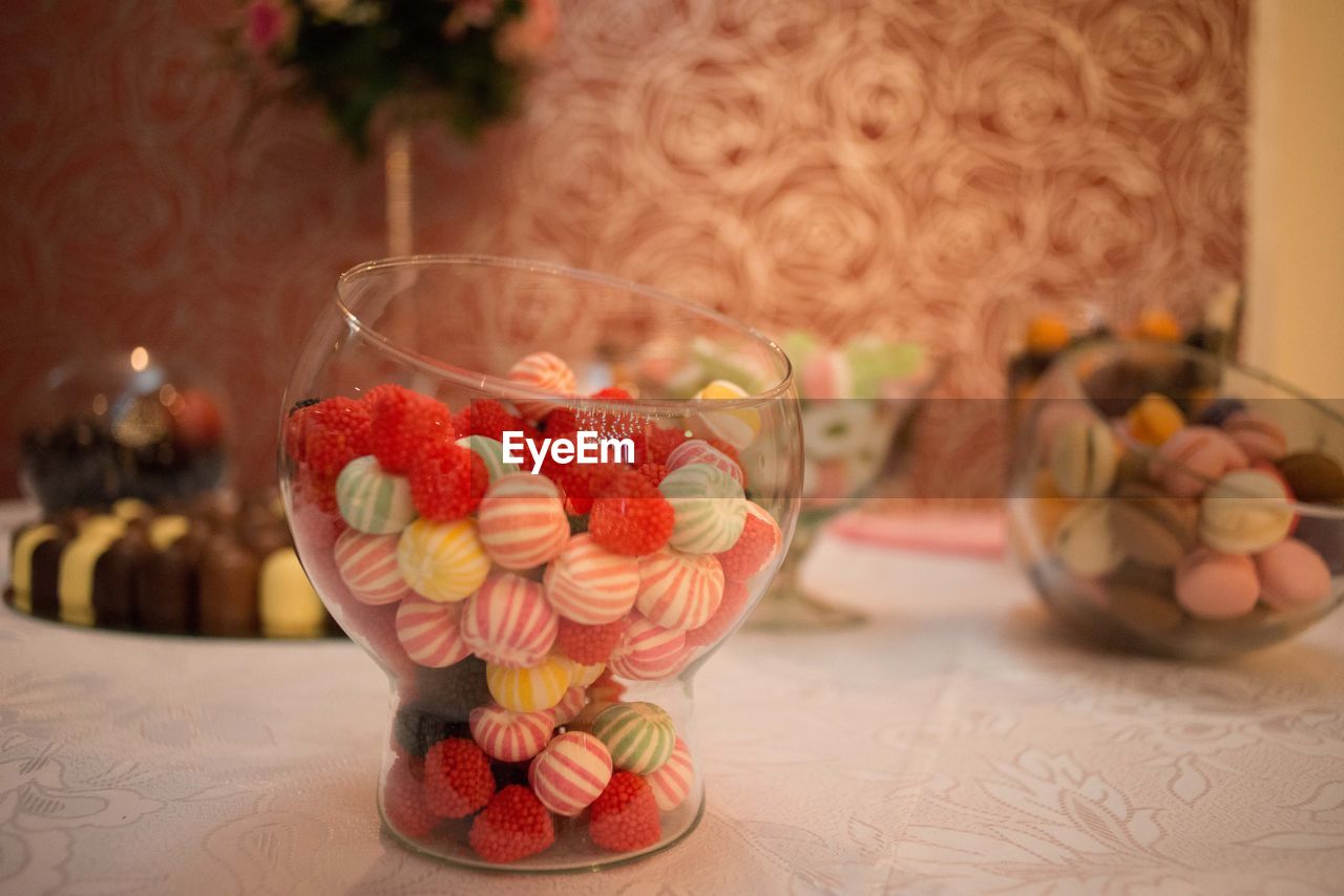 Close-up of candies in glass container on table