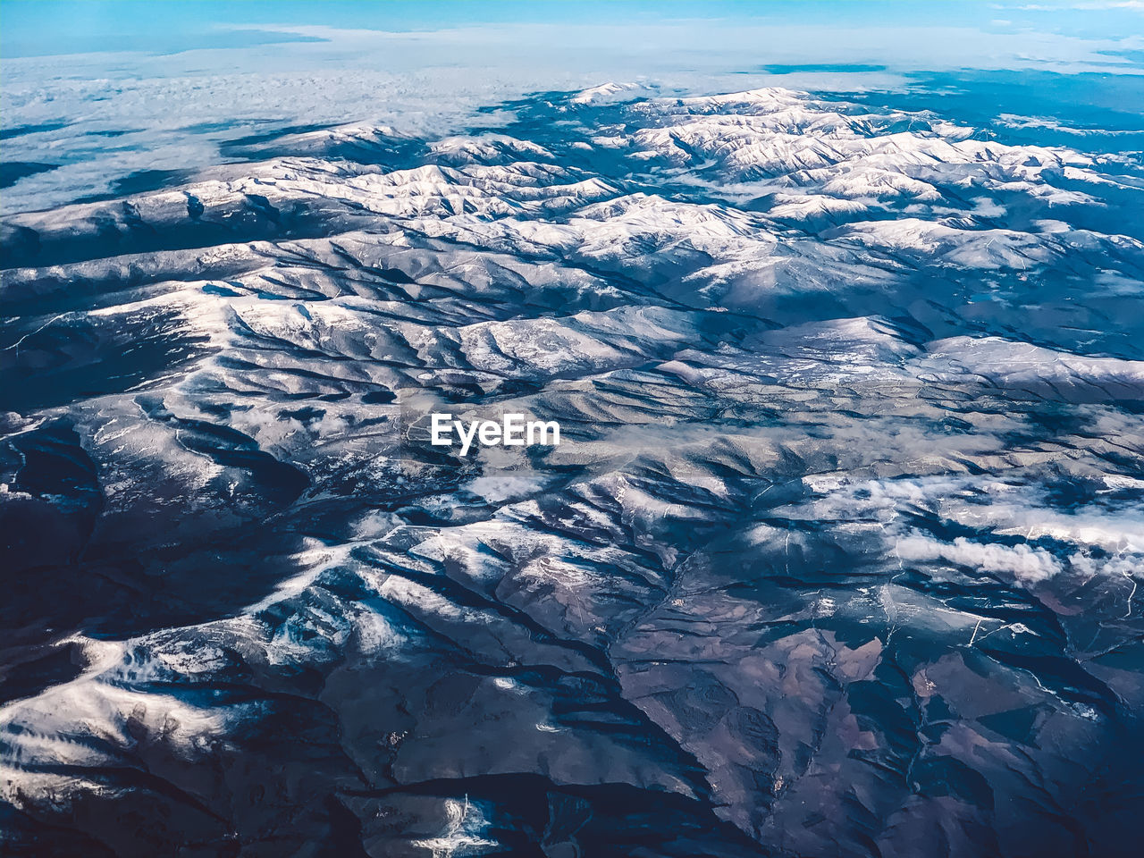 High angle view of snowcapped mountain against sky