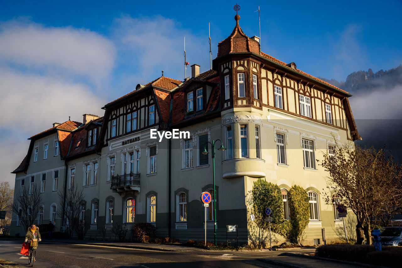 BUILDING BY ROAD AGAINST SKY