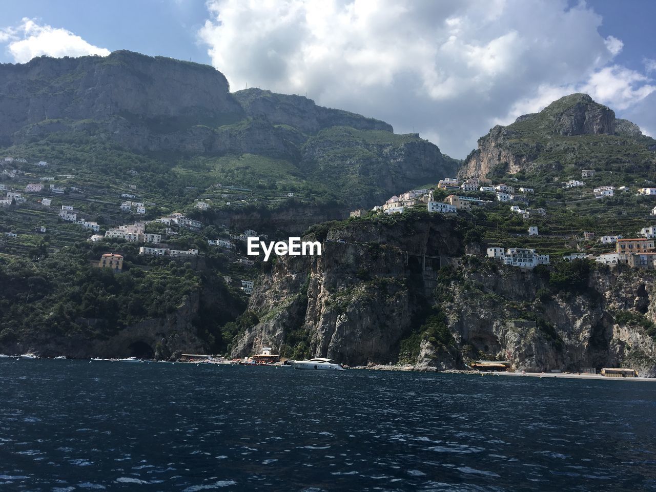 Scenic view of sea and mountains against sky