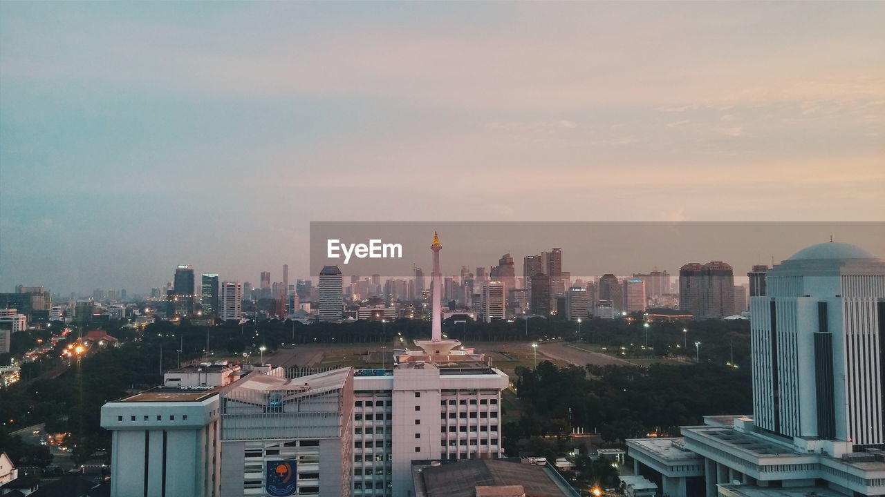 Cityscape against sky at dusk