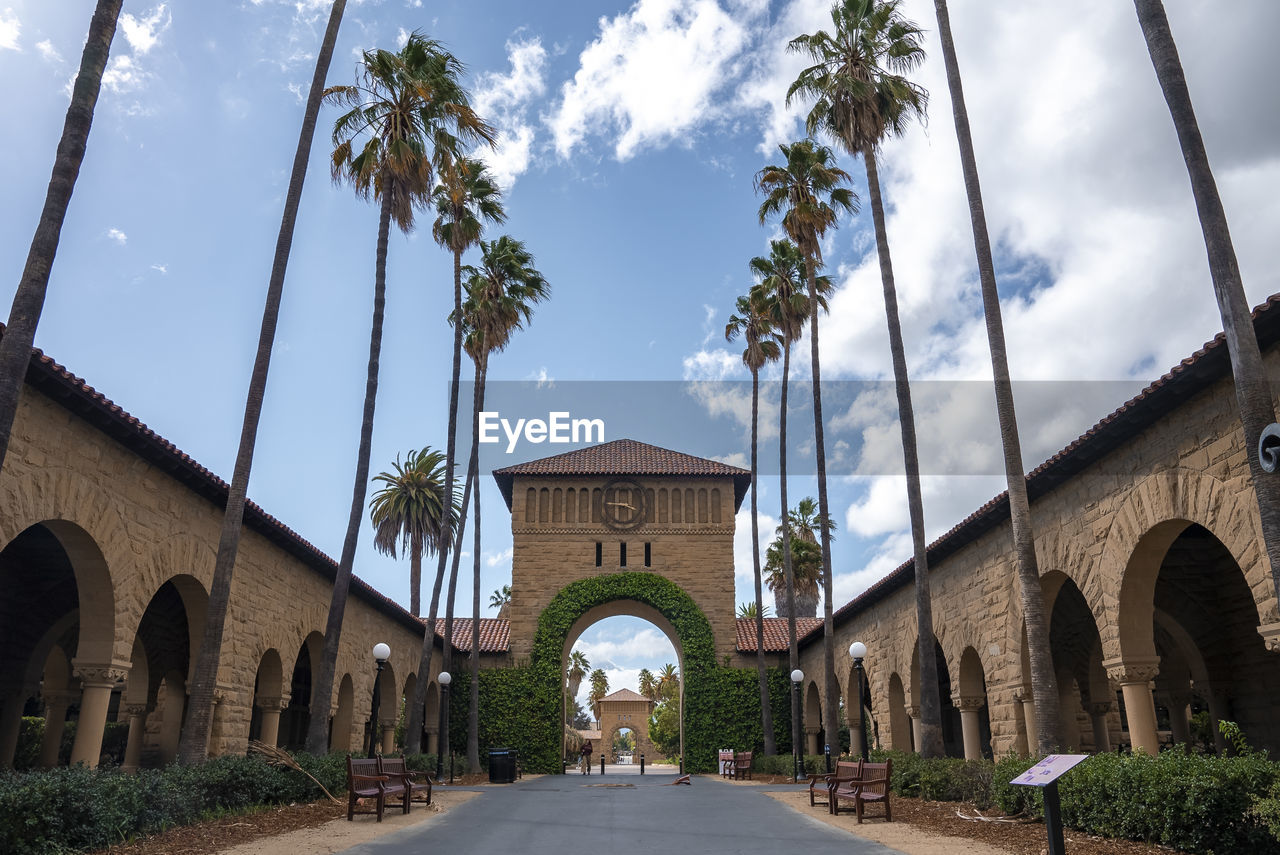 Arched built structure with ivy and clock at stanford university campus