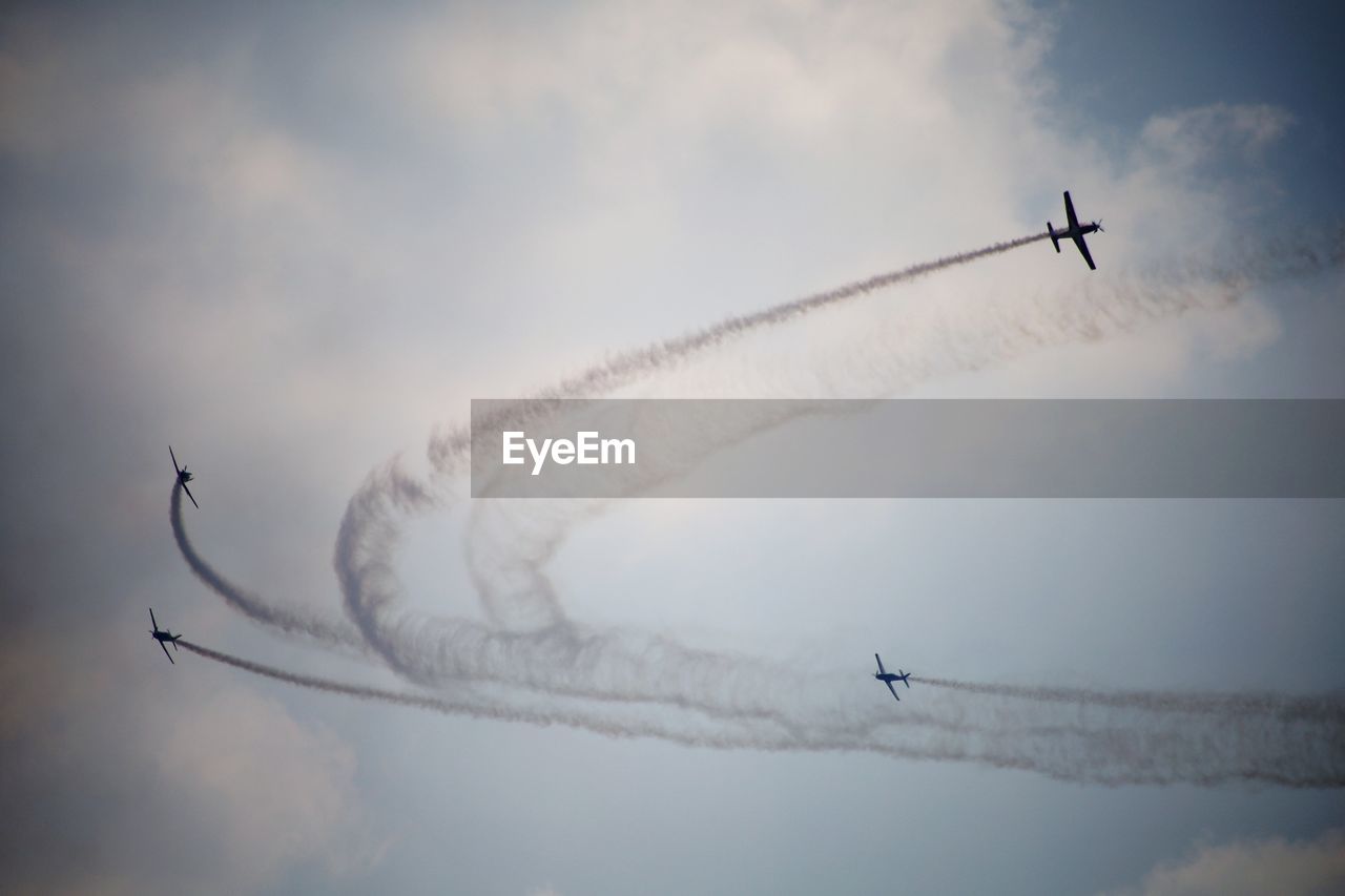 air vehicle, airplane, cloud, flying, air show, sky, transportation, mode of transportation, vapor trail, on the move, smoke, teamwork, cooperation, nature, fighter plane, motion, plane, speed, low angle view, military airplane, no people, day, vehicle, wing, mid-air, travel, performance, outdoors, skill, arrangement, order, blue, aerobatics, military