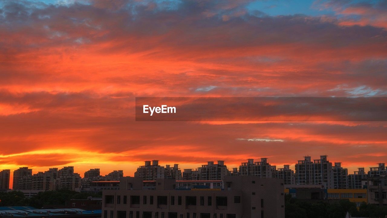 sky, architecture, city, building exterior, built structure, horizon, sunset, cloud, building, afterglow, cityscape, dusk, nature, skyline, landscape, urban skyline, evening, red sky at morning, residential district, dramatic sky, travel destinations, orange color, no people, city life, outdoors, environment, multi colored, beauty in nature, office building exterior, travel, sunlight, daytime, scenics - nature, cloudscape, romantic sky