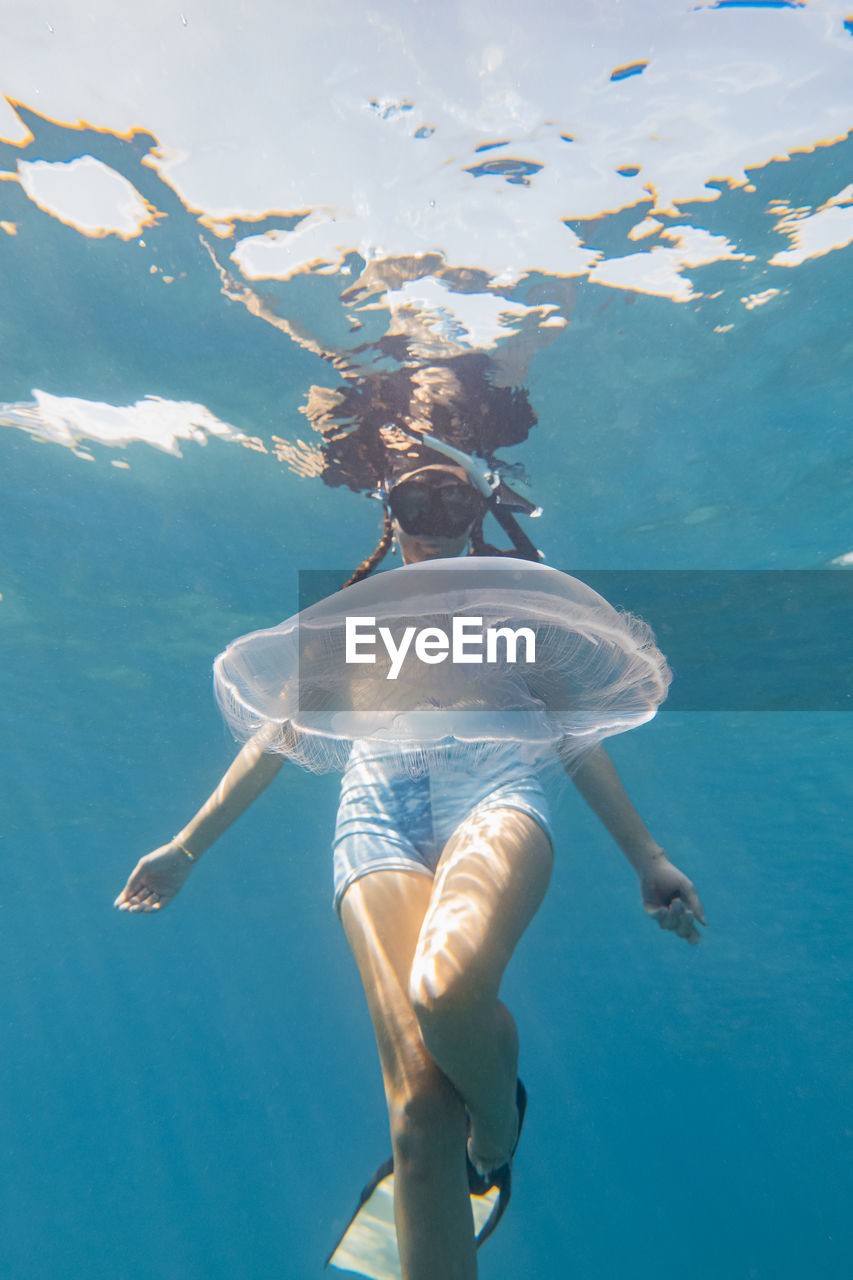 WOMAN SWIMMING POOL IN SEA