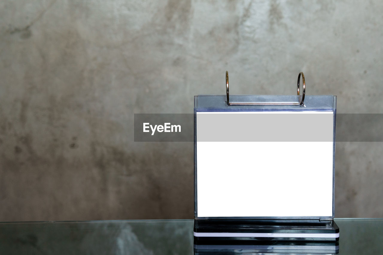 CLOSE-UP OF A WHITE WALL WITH A AN ANIMAL