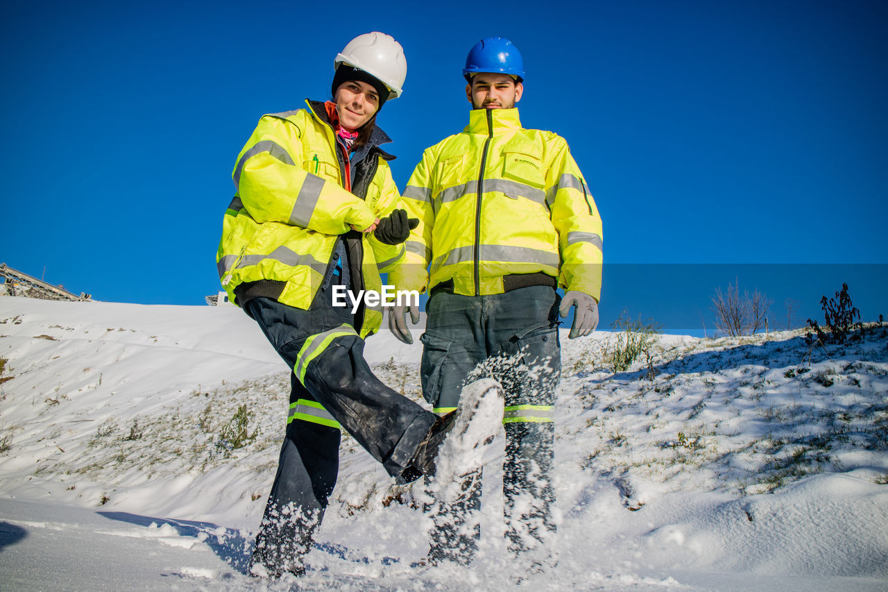 Young woman and man having fun on snow 