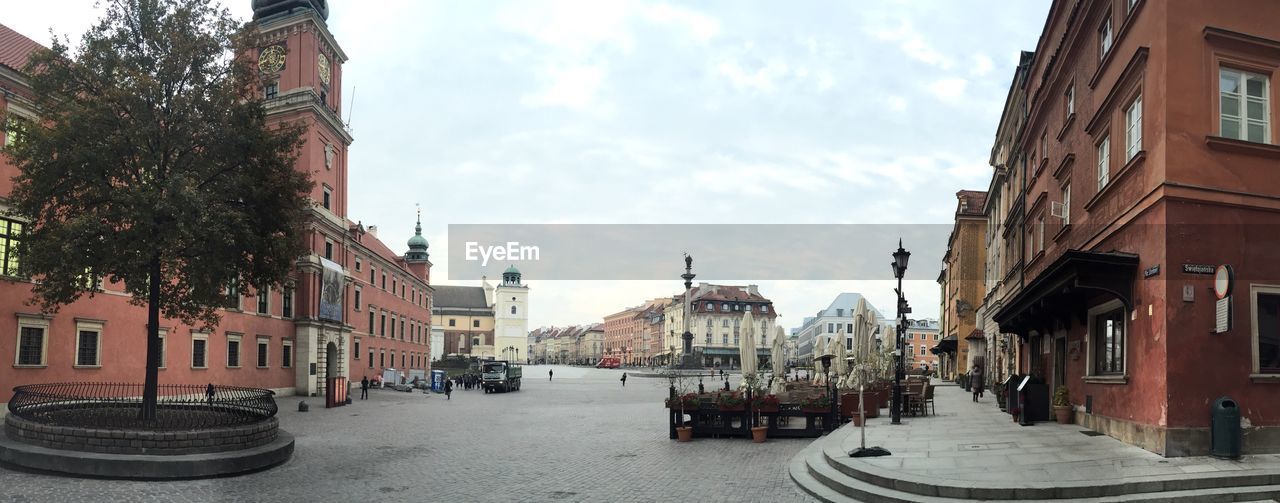 Panoramic view of city street against sky