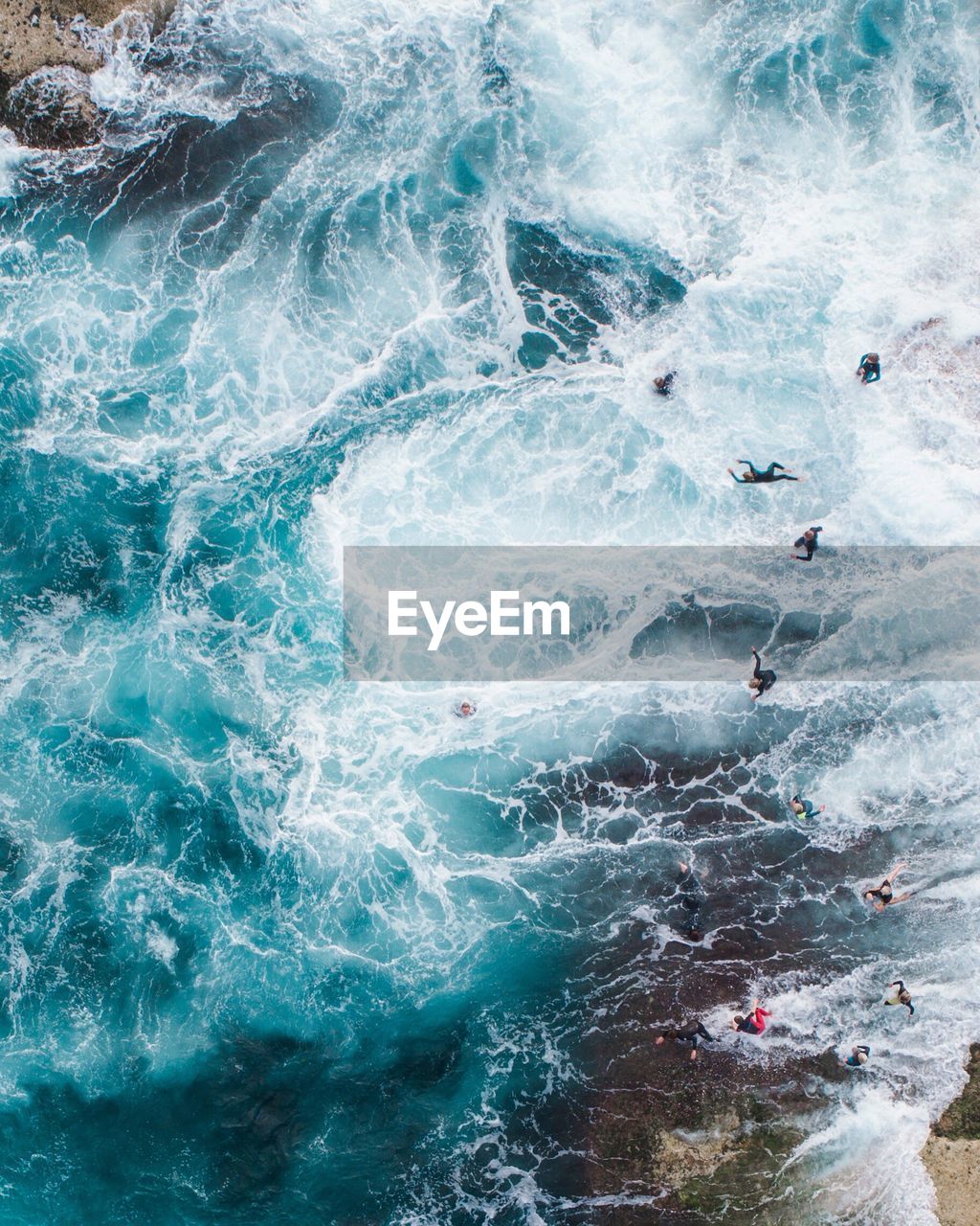 Aerial view of people swimming in sea