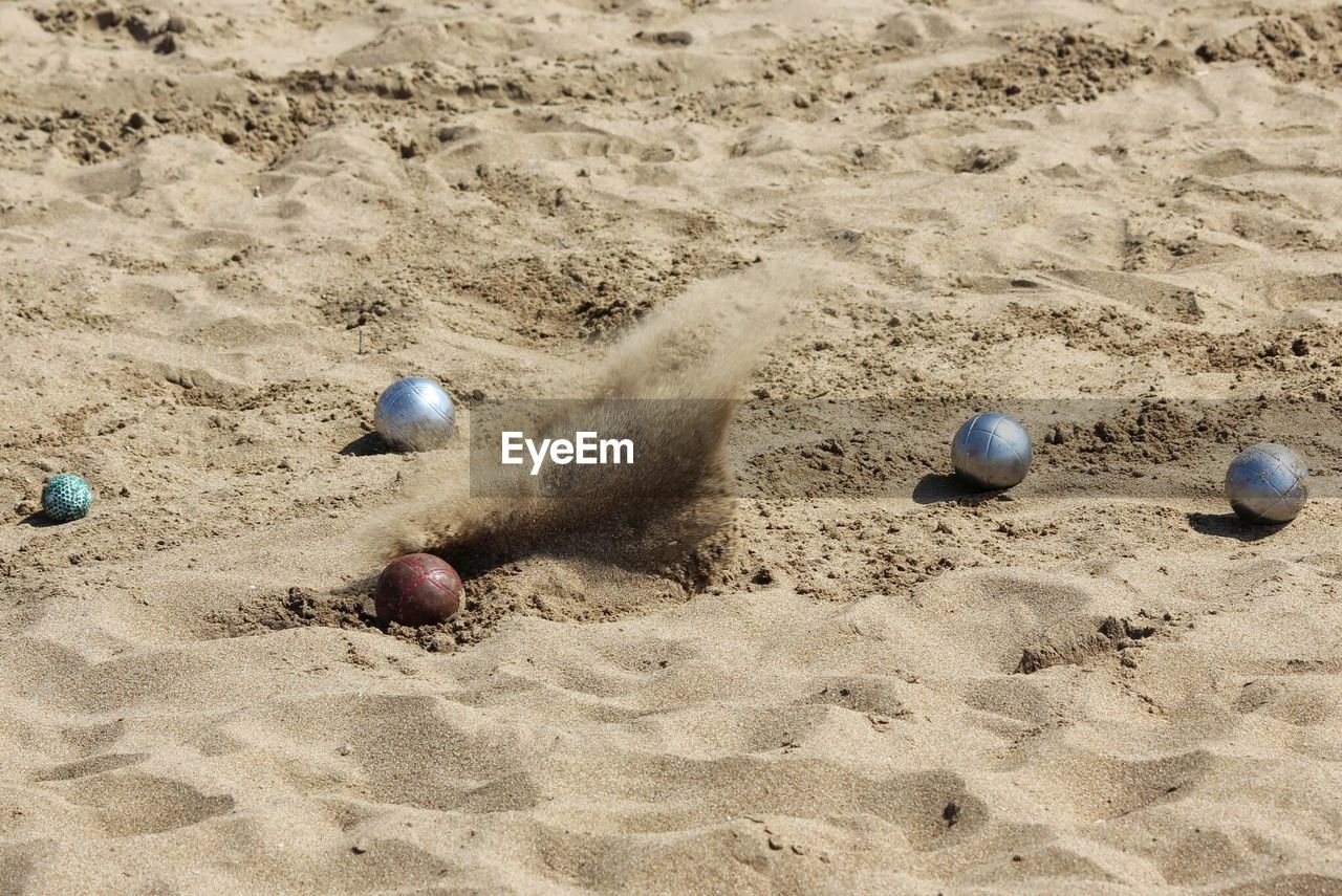 CHILDREN PLAYING BALL ON SAND