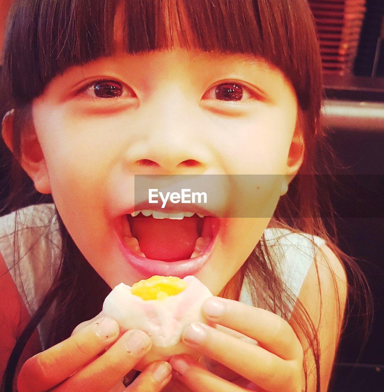 Close-up portrait of cute girl eating food