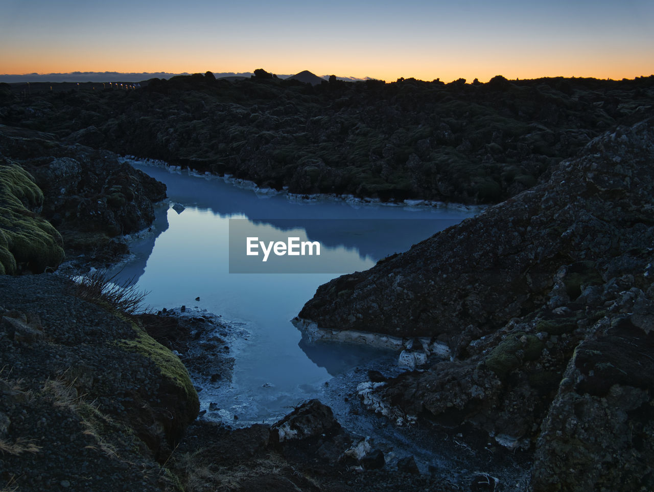 SCENIC VIEW OF ROCKS AT SUNSET