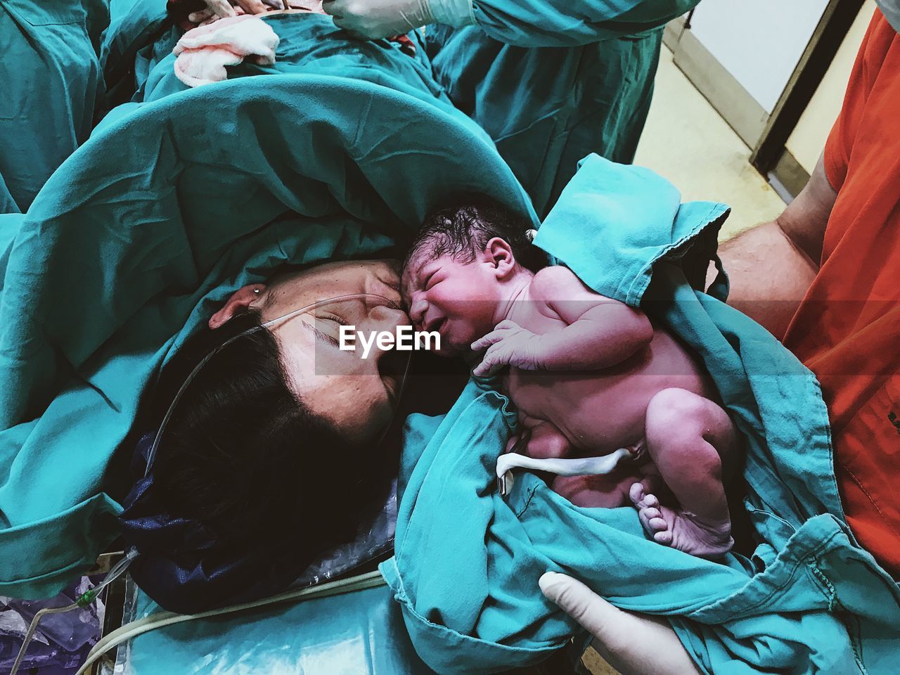 Mother kissing son in hospital ward