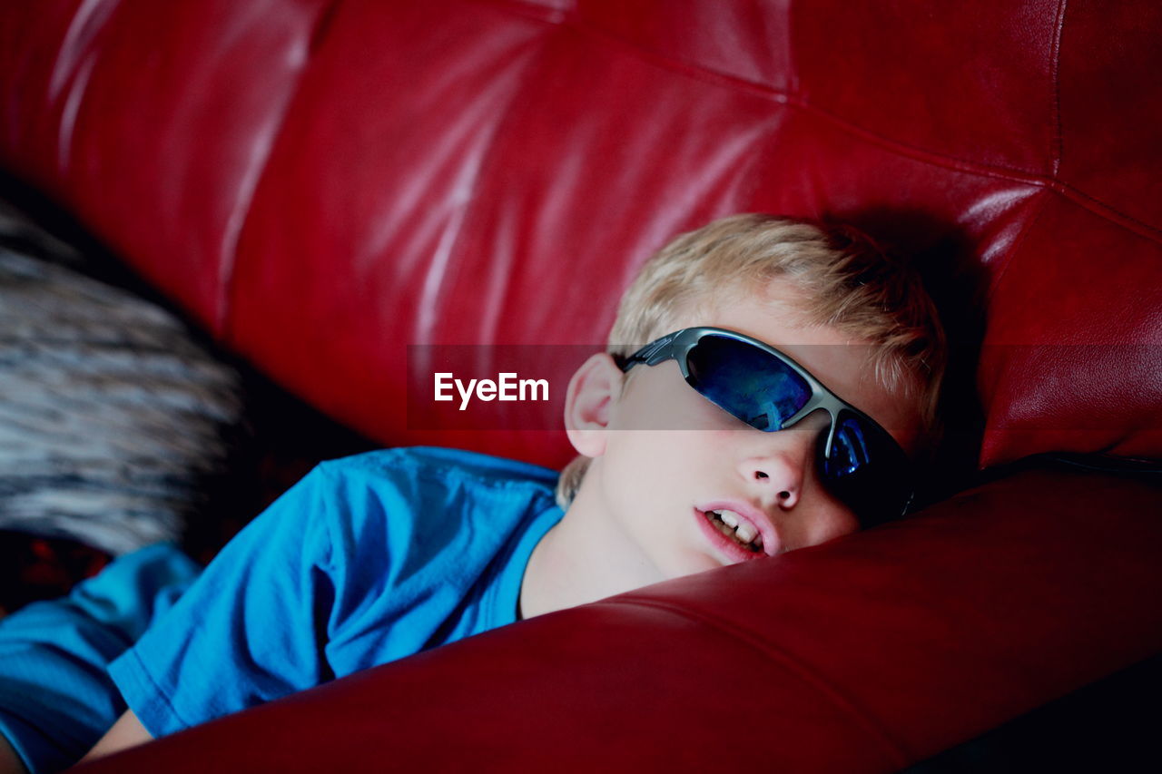 Boy relaxing on couch at home