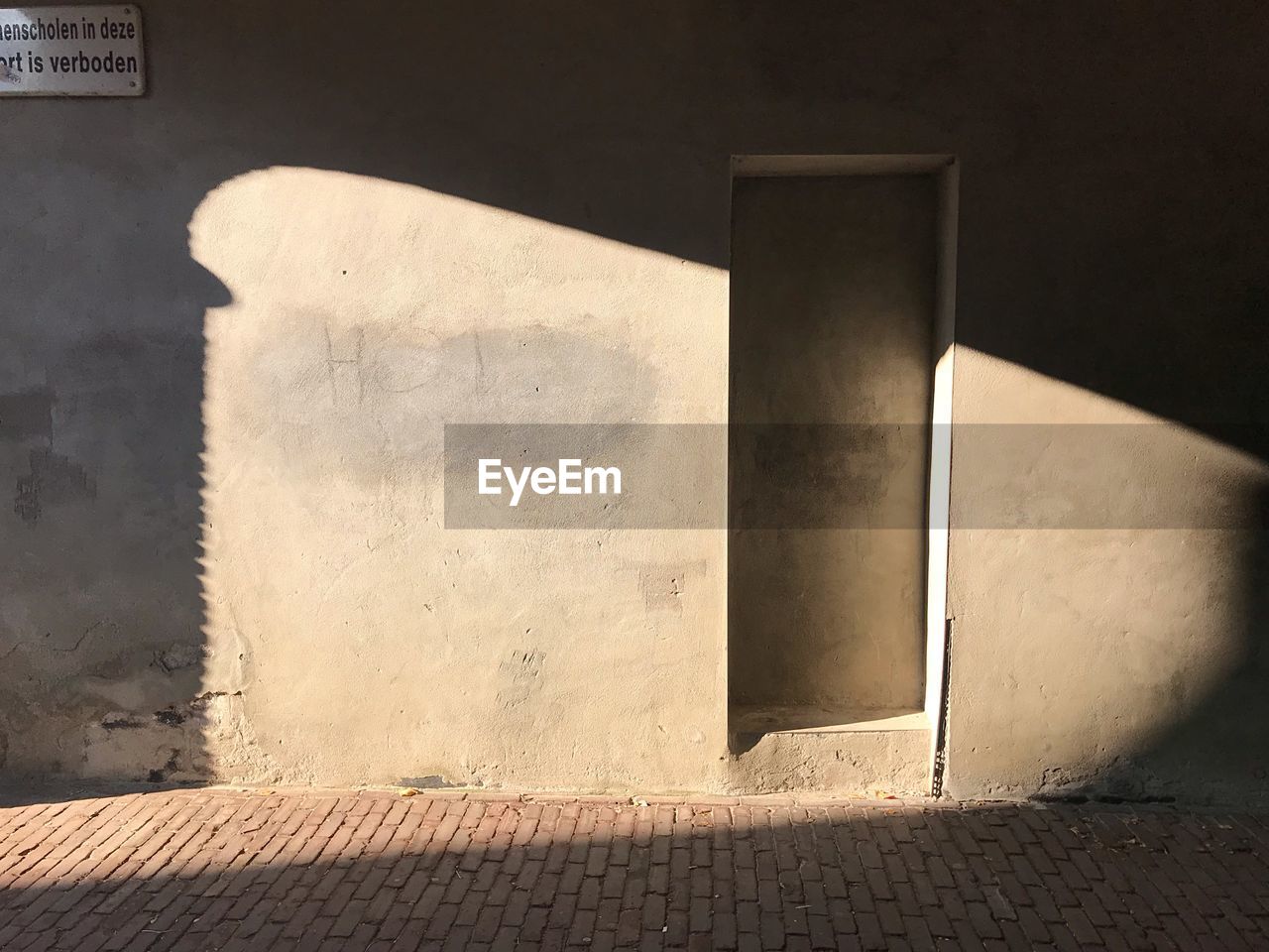 SHADOW ON WALL BY BUILDING