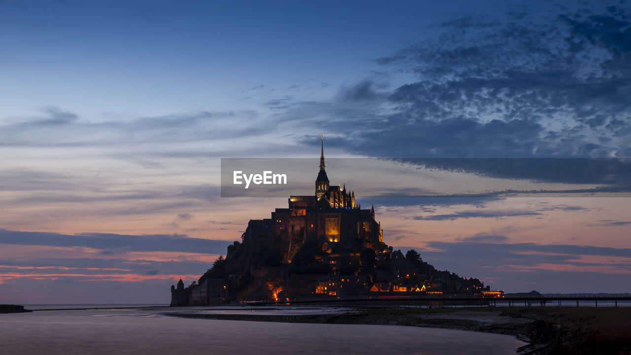 Panoramic view of the famous abbey of le mont saint-michel at sunset, normandy, france