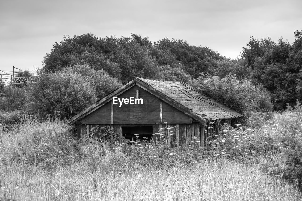 VIEW OF HOUSE ON GRASSY FIELD