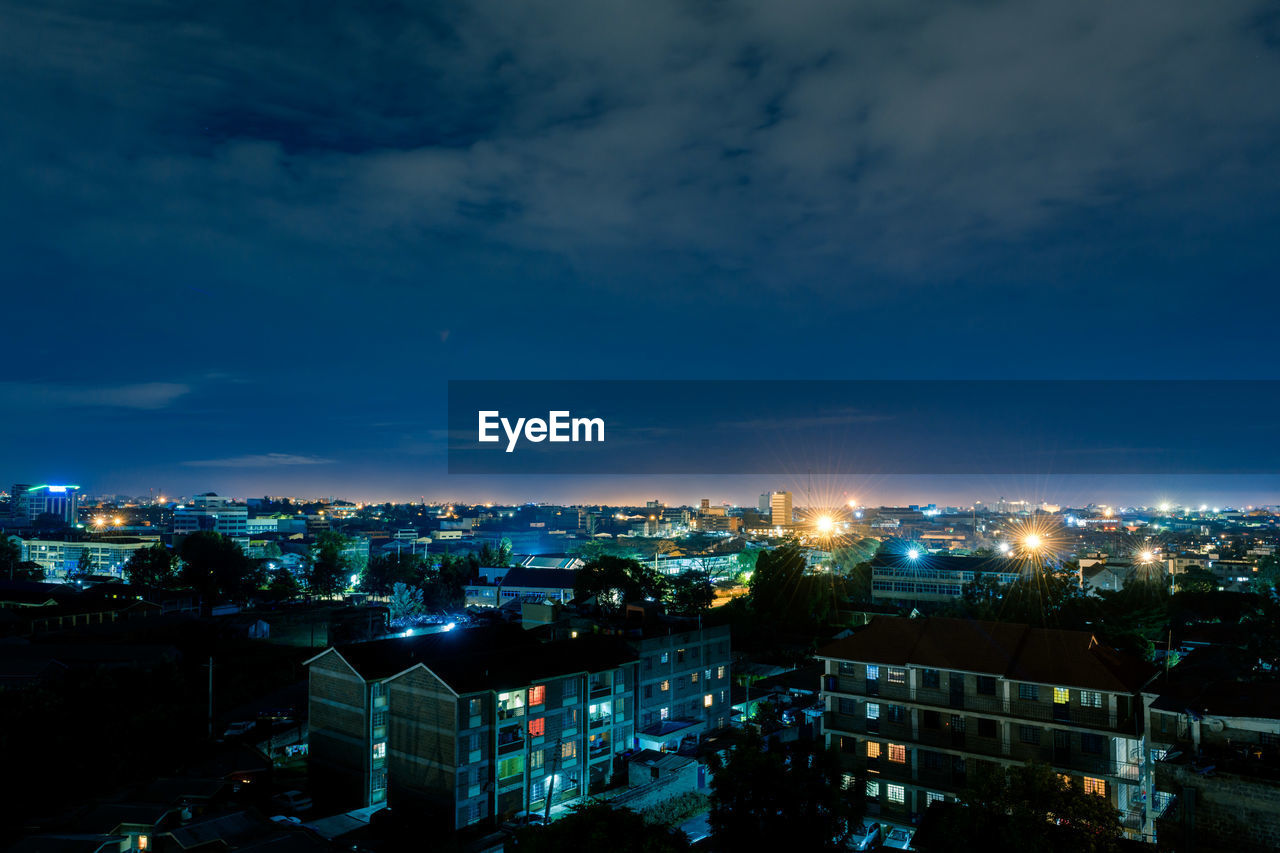 High angle view of illuminated buildings against sky at dusk