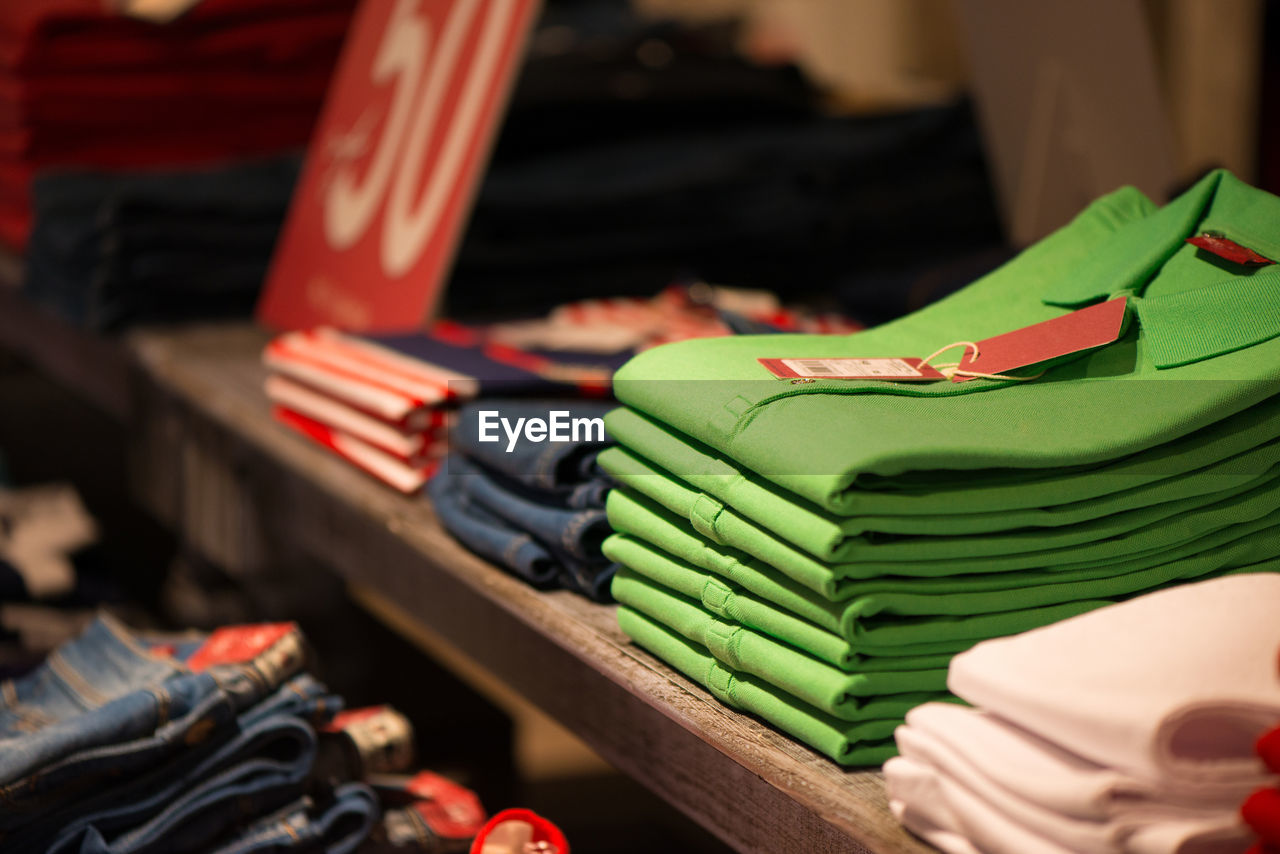 Close-up of shirts on shelf for sale at store