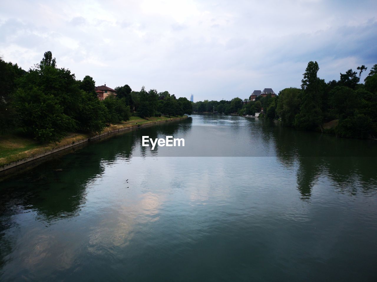 RIVER AMIDST TREES AGAINST SKY