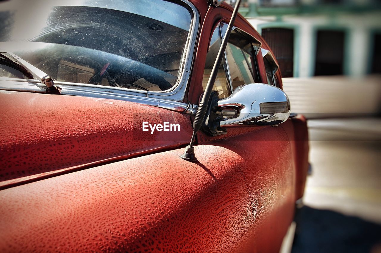 Close-up of red car on road