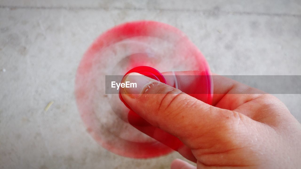 Close-up of hand holding fidget spinner