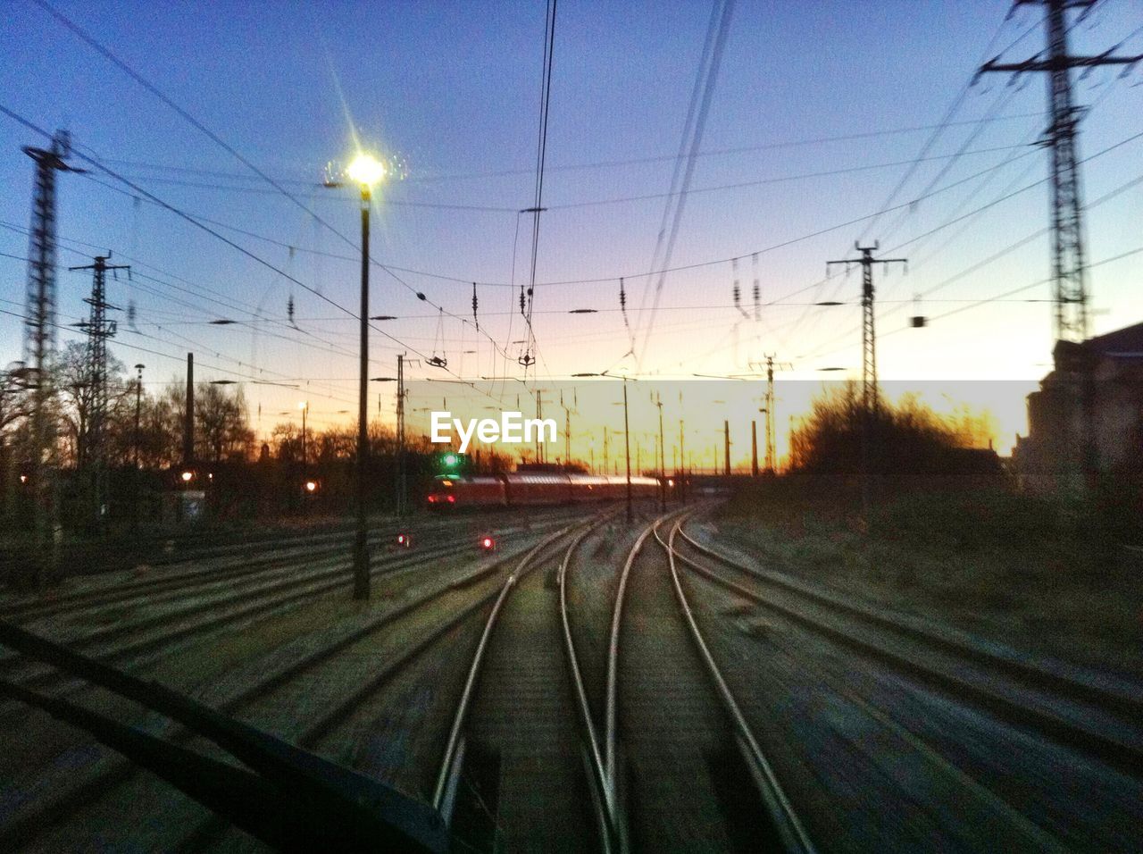 View of railroad tracks through train windshield