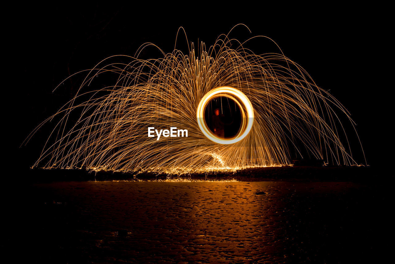 Person spinning wire wool at beach