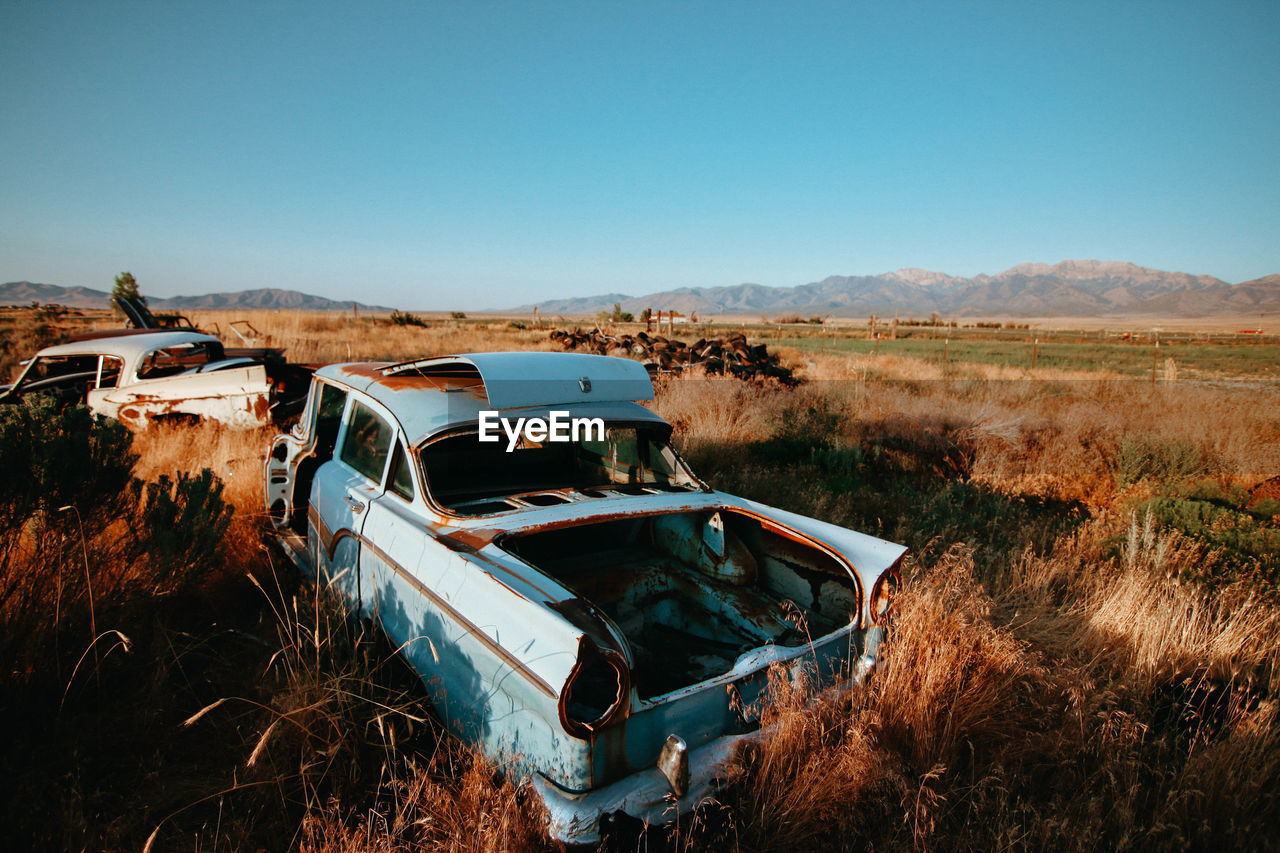 ABANDONED CAR AGAINST CLEAR SKY