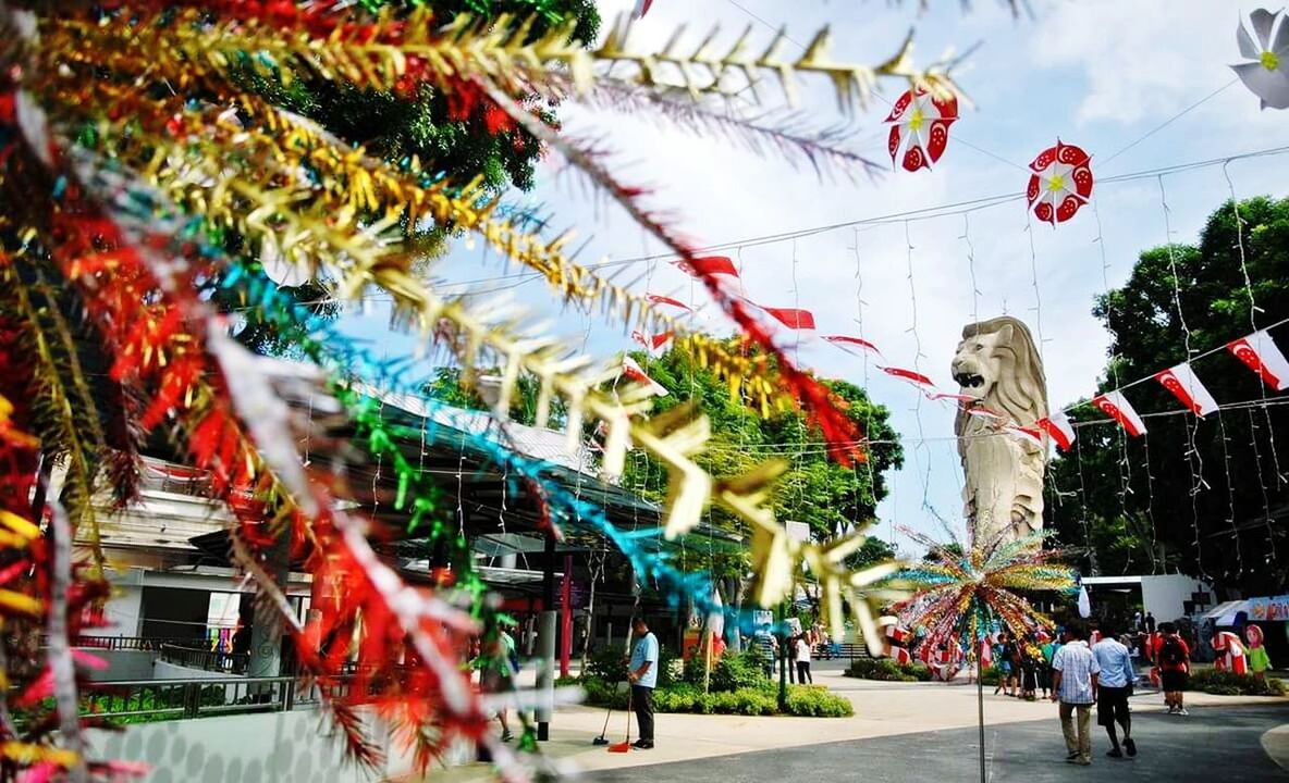 Decorated city street against cloudy sky