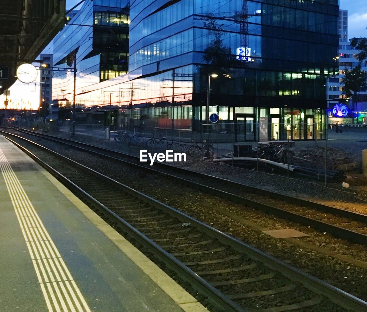 Railroad tracks against sky at night