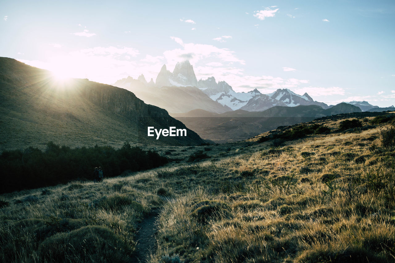 Scenic view of snowcapped mountain peak against sunset sky