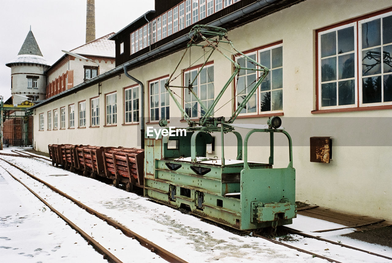 RAILROAD TRACKS BY BUILDINGS DURING WINTER