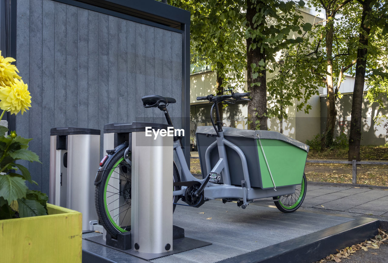 Germany, bavaria, munich, electric rental cargo bike charging at station
