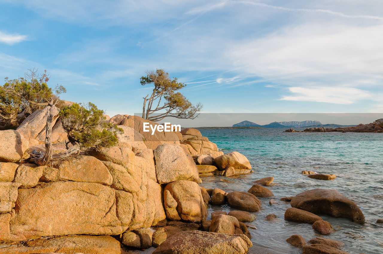 Rocks on beach against sky